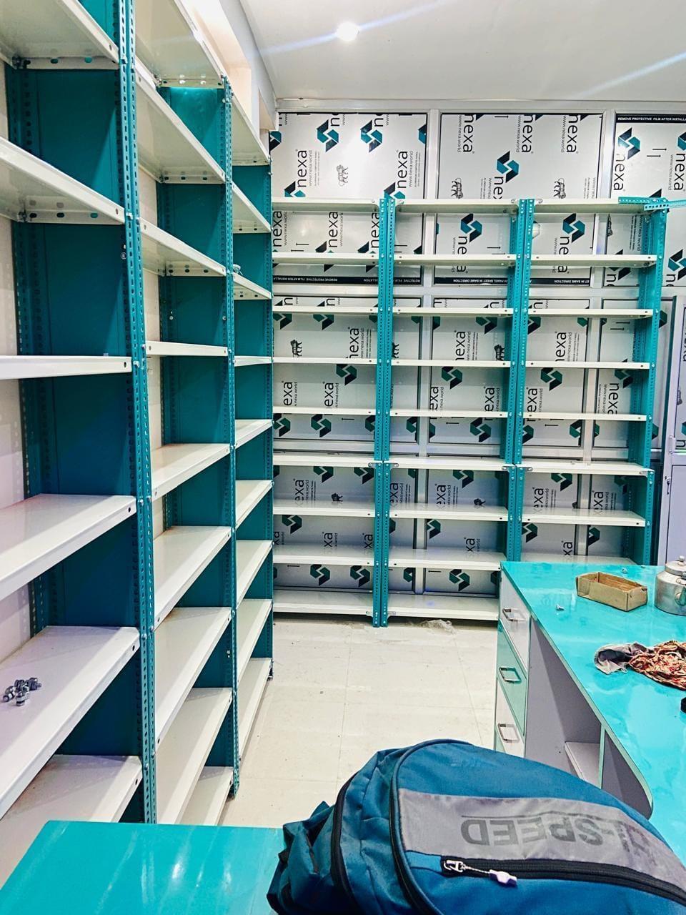 Shelving along a wall and beside the counter in a medical store